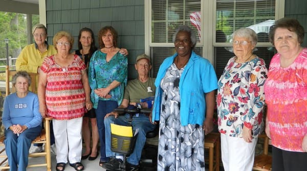 Group of people on front porch of house